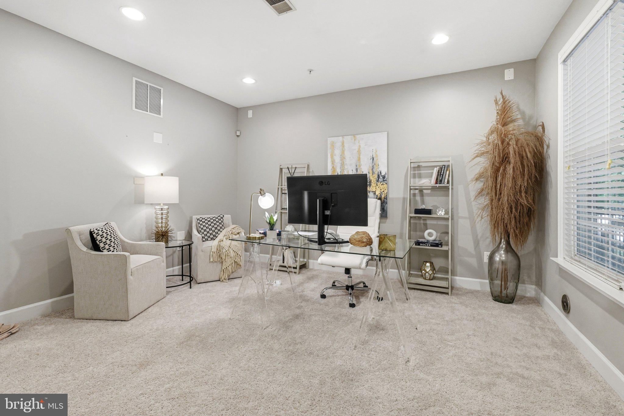 772 Raven Avenue Gaithersburg, MD 20877 - Photo 4 of 30 a living room with furniture a flat screen tv and a refrigerator