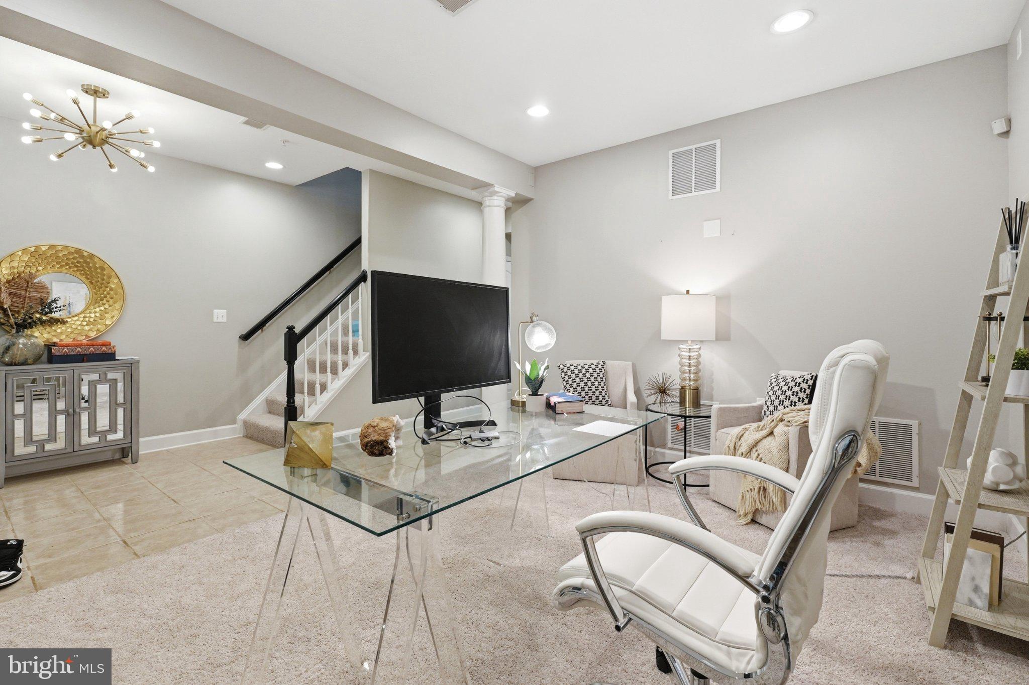 772 Raven Avenue Gaithersburg, MD 20877 - Photo 5 of 30 a living room with furniture a flat screen tv and a chandelier