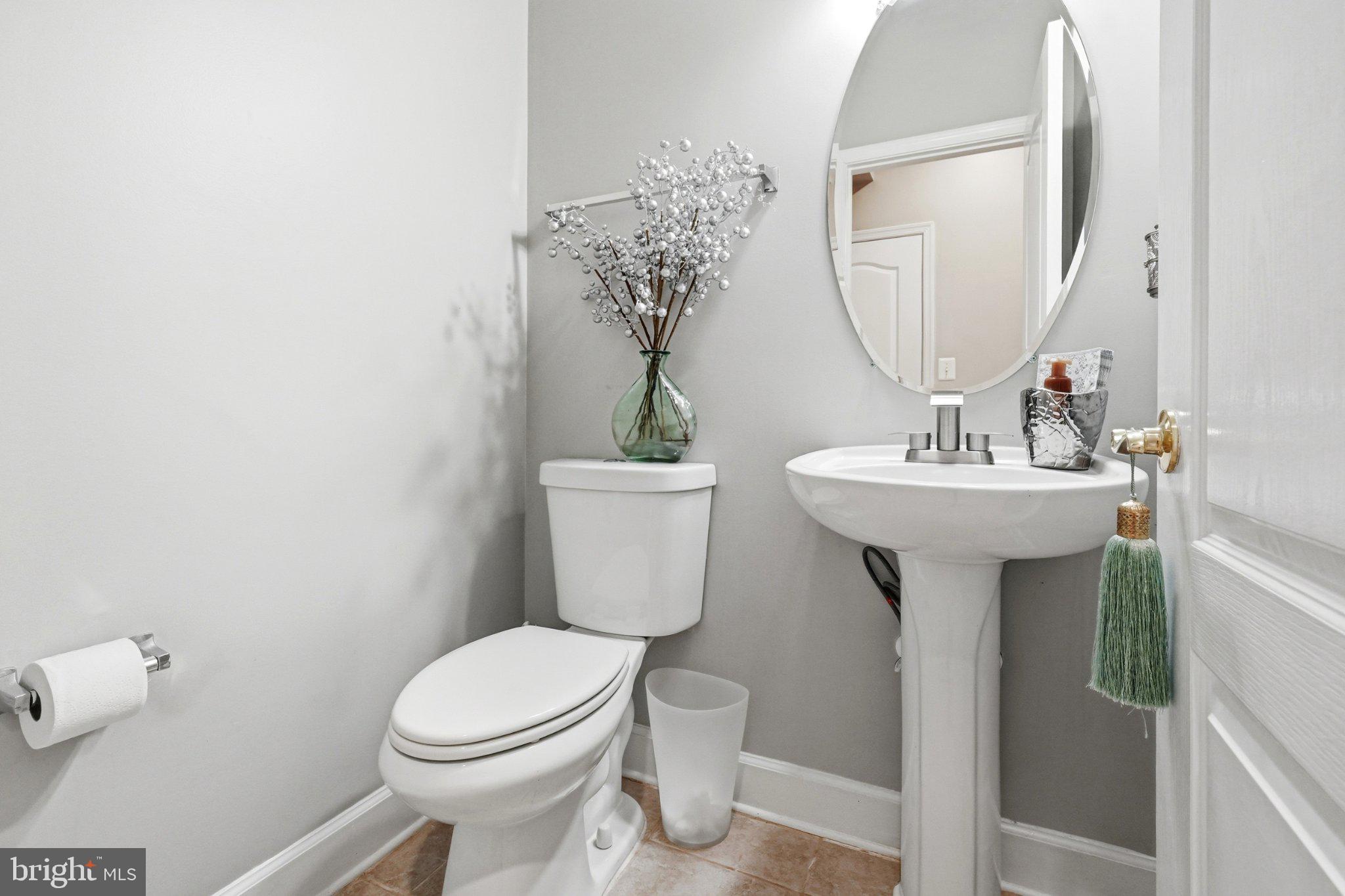 772 Raven Avenue Gaithersburg, MD 20877 - Photo 7 of 30 a bathroom with a sink toilet and mirror