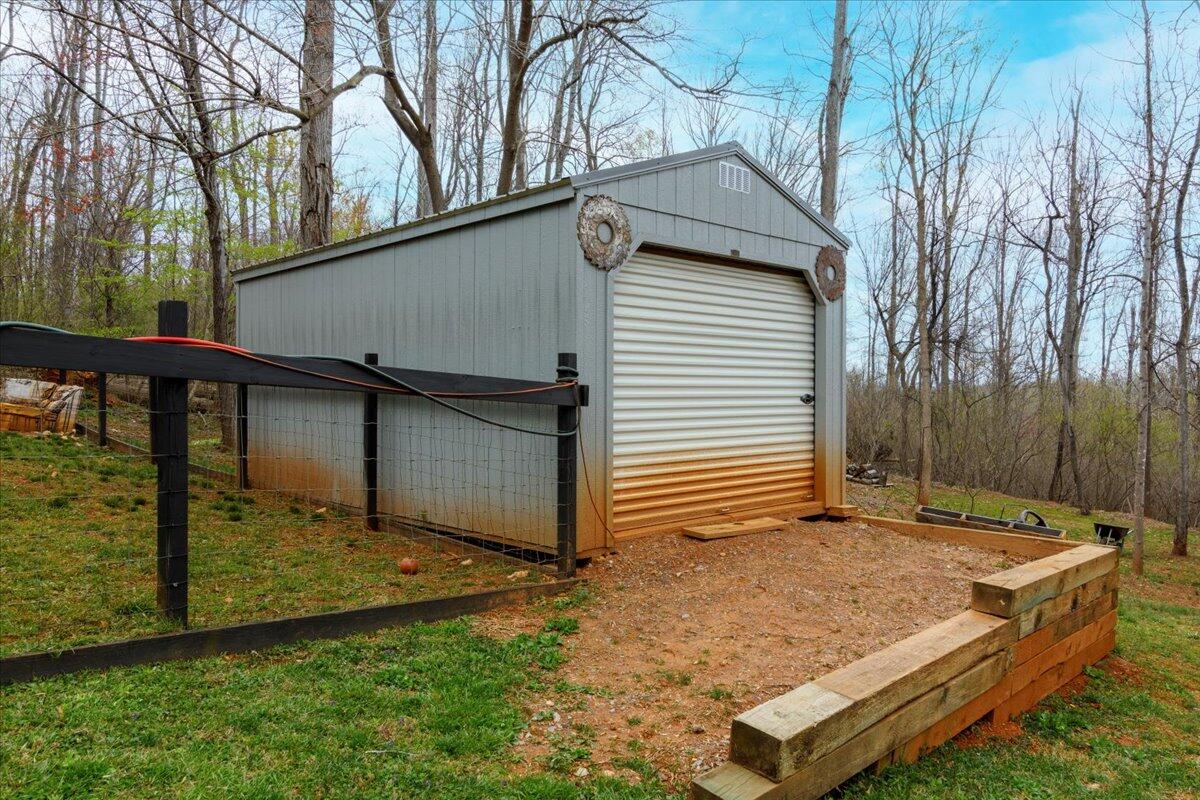 148 Cobblestone Drive Lynchburg, VA 24502 - Photo 28 of 30 a backyard of a house with large trees and outdoor seating