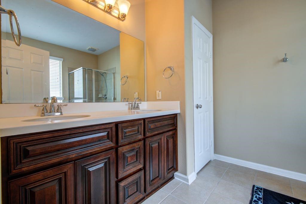 4411 Enchanted Spring Court Sugar Land, TX 77479 - Photo 11 of 21 a bathroom with a sink and a mirror