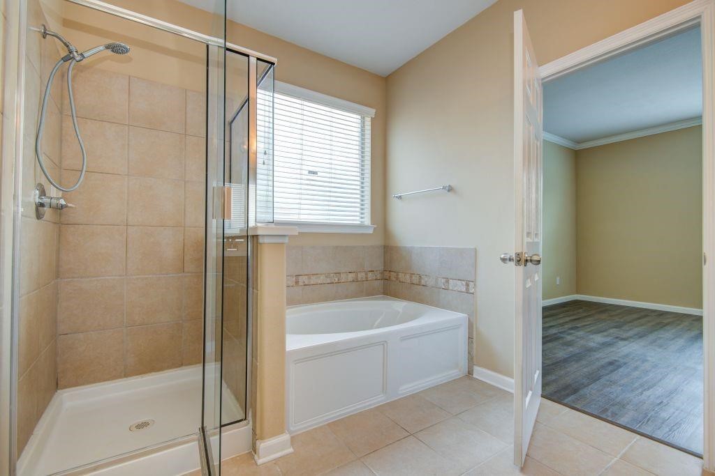 4411 Enchanted Spring Court Sugar Land, TX 77479 - Photo 12 of 21 a bathroom with a bathtub and a shower