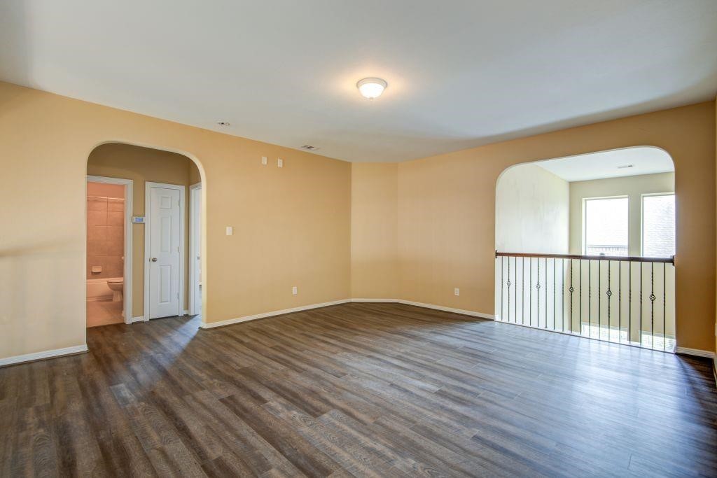 4411 Enchanted Spring Court Sugar Land, TX 77479 - Photo 17 of 21 a view of an empty room with wooden floor and a window