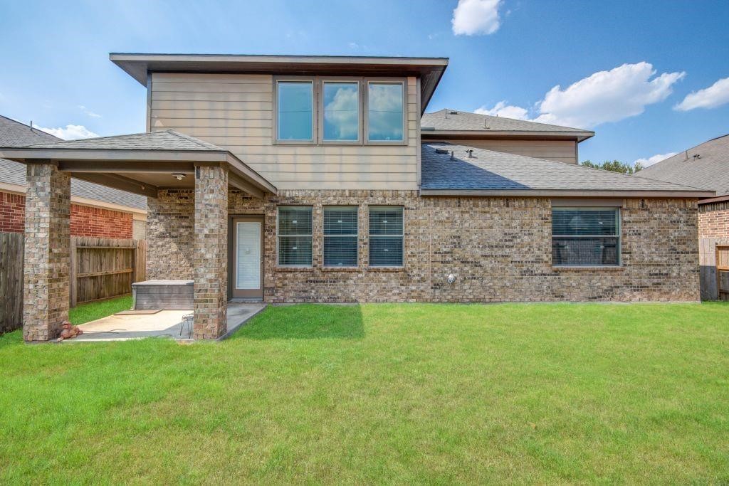 4411 Enchanted Spring Court Sugar Land, TX 77479 - Photo 18 of 21 a front view of a house with a garden