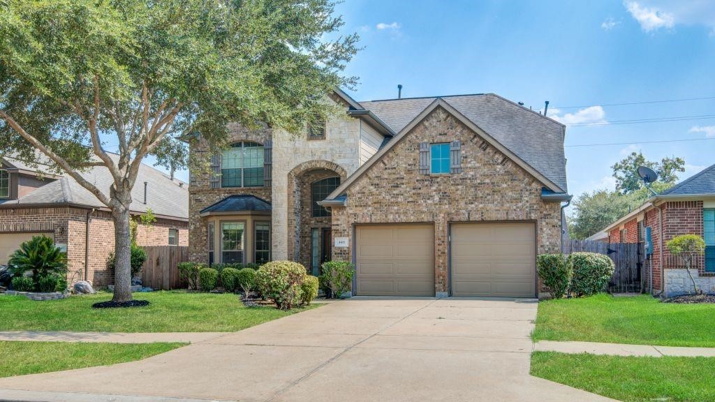 4411 Enchanted Spring Court Sugar Land, TX 77479 - Photo 2 of 21 a front view of a house with a yard