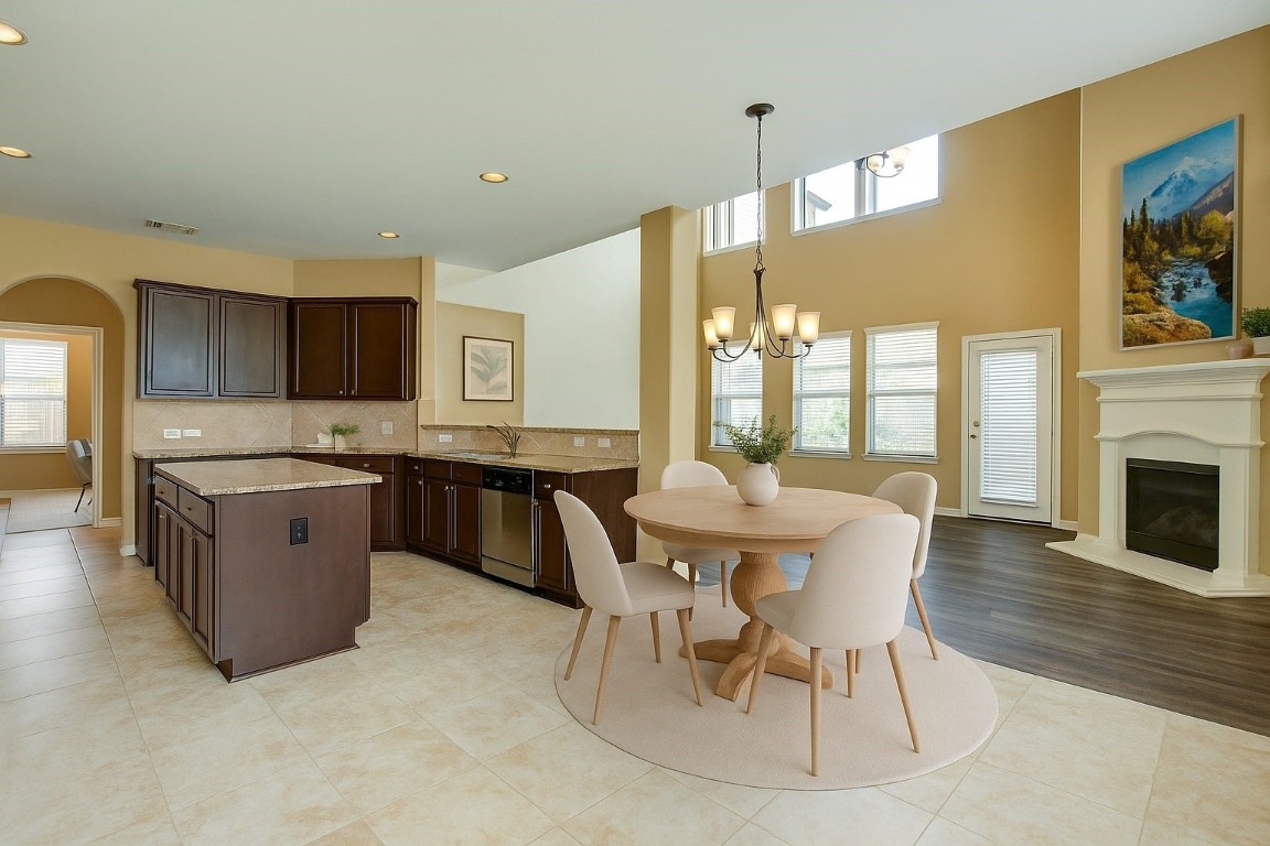 4411 Enchanted Spring Court Sugar Land, TX 77479 - Photo 7 of 21 a kitchen with stainless steel appliances kitchen island granite countertop a stove a sink a dining table and chairs