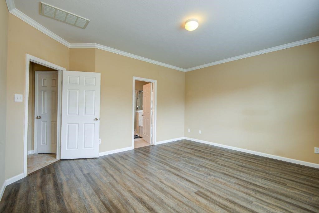 4411 Enchanted Spring Court Sugar Land, TX 77479 - Photo 10 of 21 a view of an empty room with wooden floor and a window