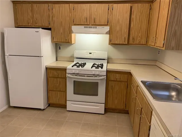 a kitchen with a stove top oven and cabinets