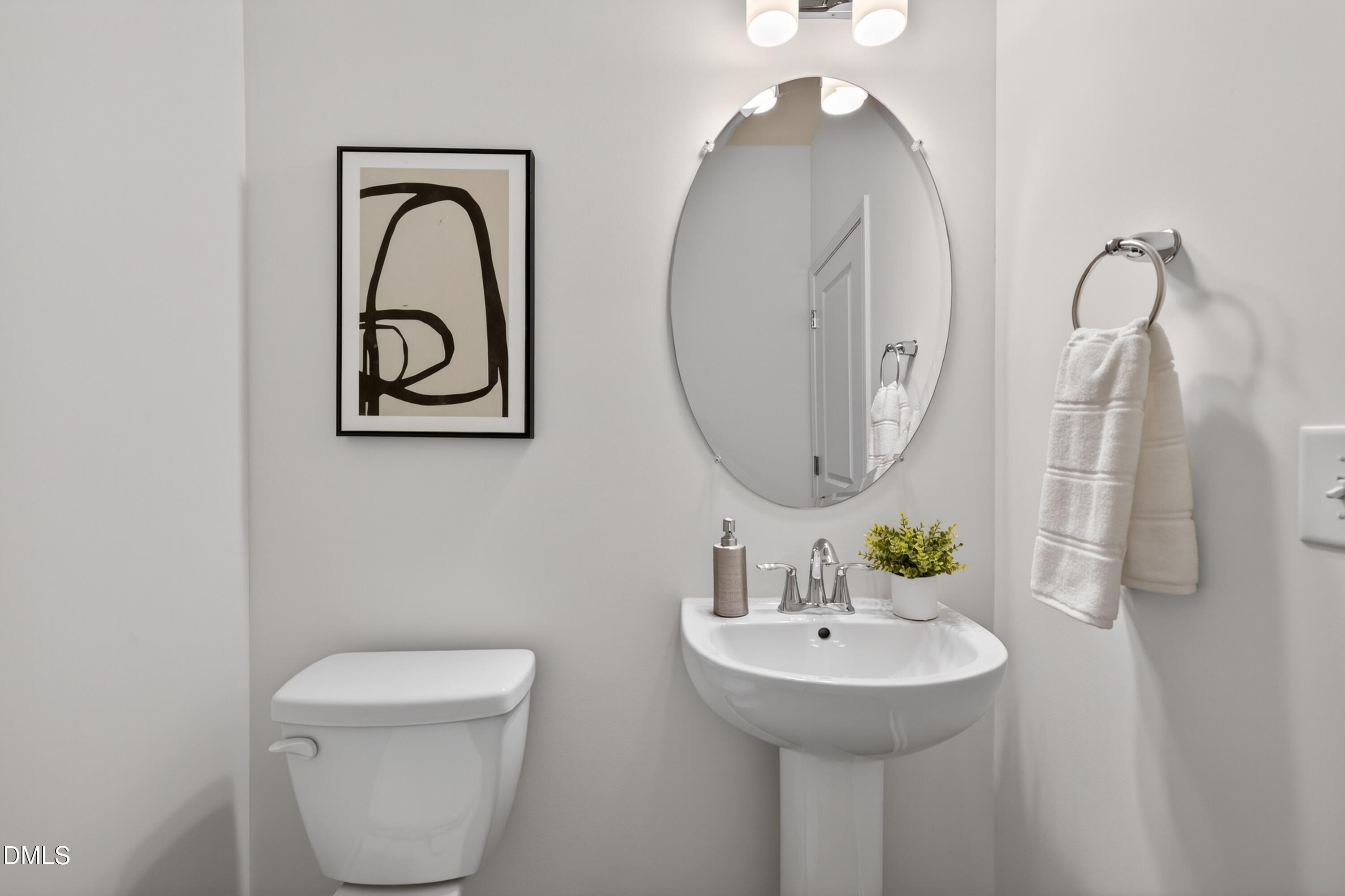 415 Plentiful Way, Unit 108 Benson, NC 27504 - Photo 14 of 31 a bathroom with a toilet sink and mirror