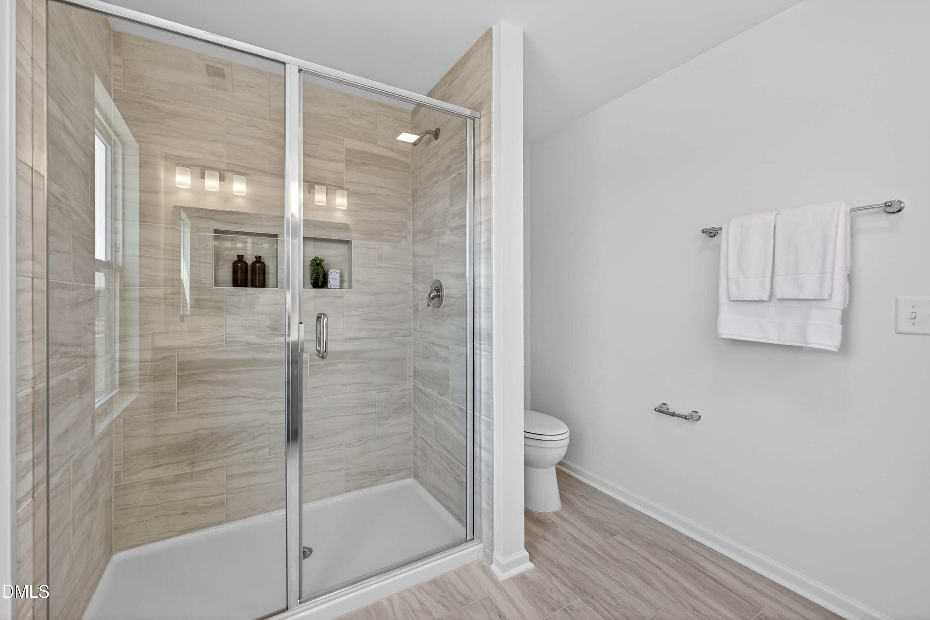 415 Plentiful Way, Unit 108 Benson, NC 27504 - Photo 21 of 31 a bathroom with a glass shower door