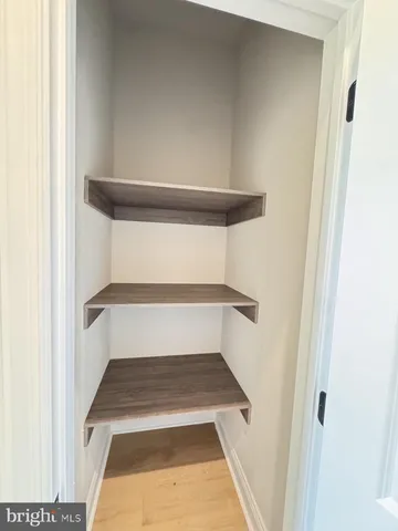 a bathroom with a granite countertop sink toilet and mirror