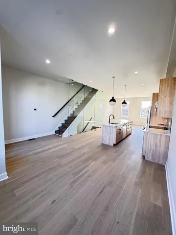 a room with wooden floors and stairs