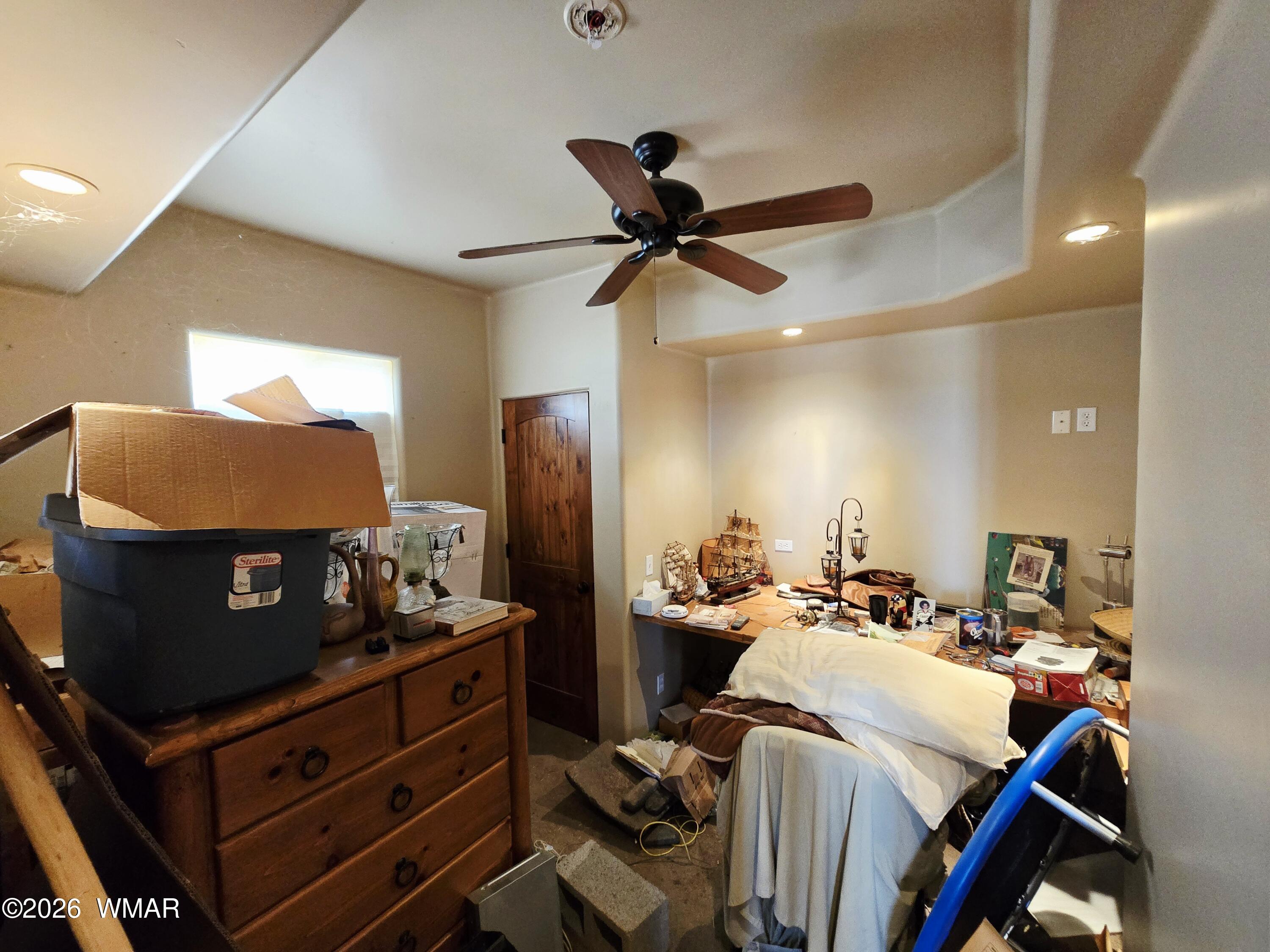 9046 Miller Trail Snowflake, AZ 85937 - Photo 17 of 34 a bed room with furniture and a ceiling fan
