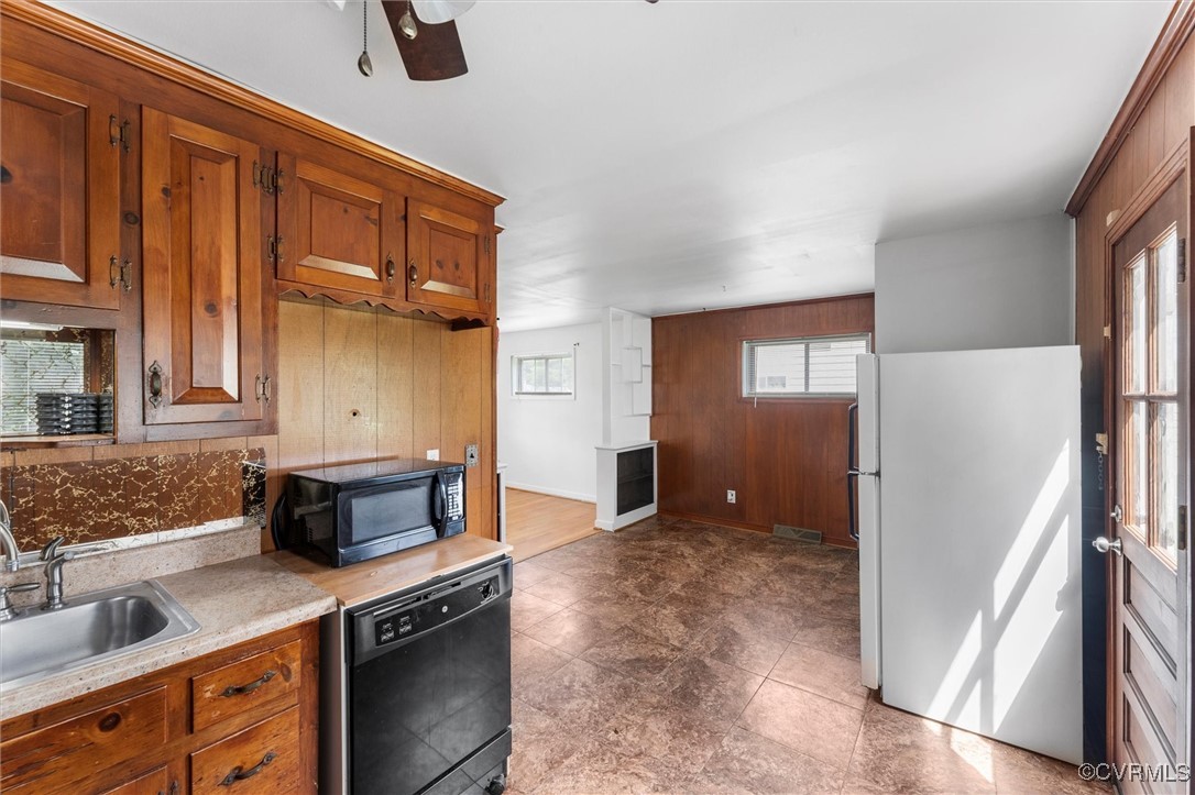 5425 Germain Road Richmond, VA 23224 - Photo 27 of 37 Kitchen with black appliances, wood walls, brown c