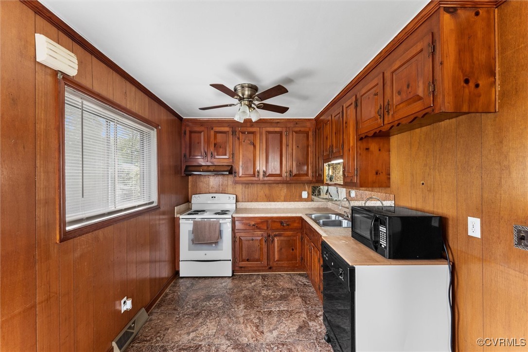 5425 Germain Road Richmond, VA 23224 - Photo 30 of 37 Kitchen with black appliances, brown cabinetry, li