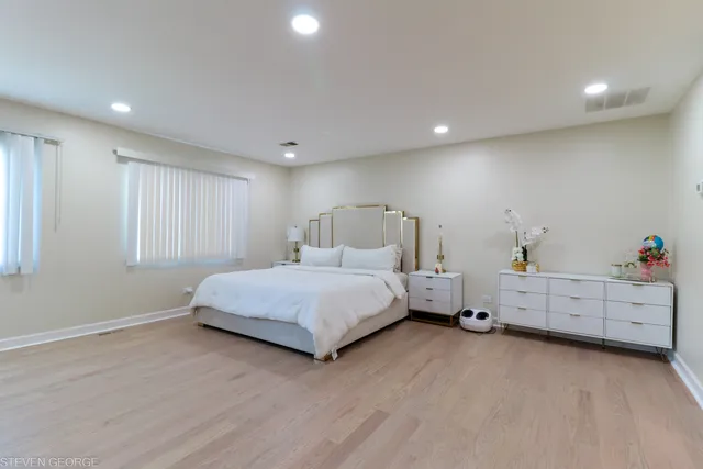 a bedroom with a bed and a dresser