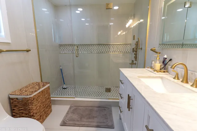 a bathroom with a sink a toilet and mirror