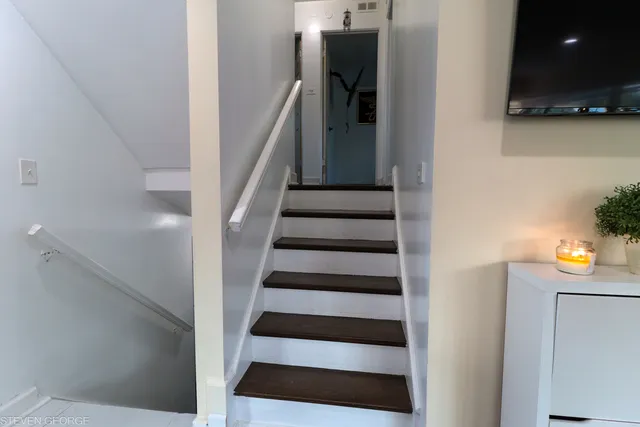 a view of entryway and hall with wooden floor