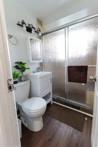 a bathroom with a toilet sink and mirror