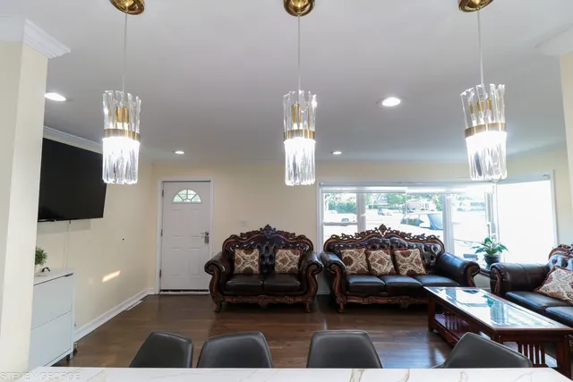 a living room with furniture a flat screen tv and a large window