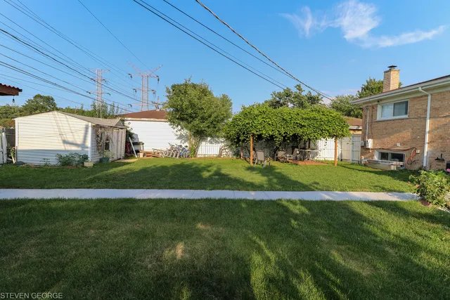 a view of a house with a big yard and potted plants