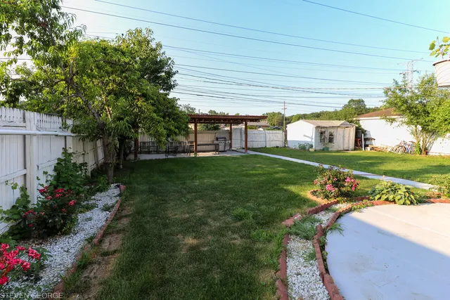 a view of a house with a backyard and sitting area
