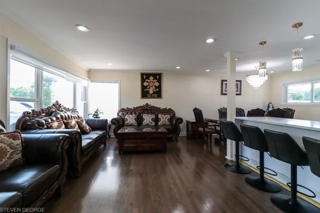 a living room with lots of furniture and a wooden floor