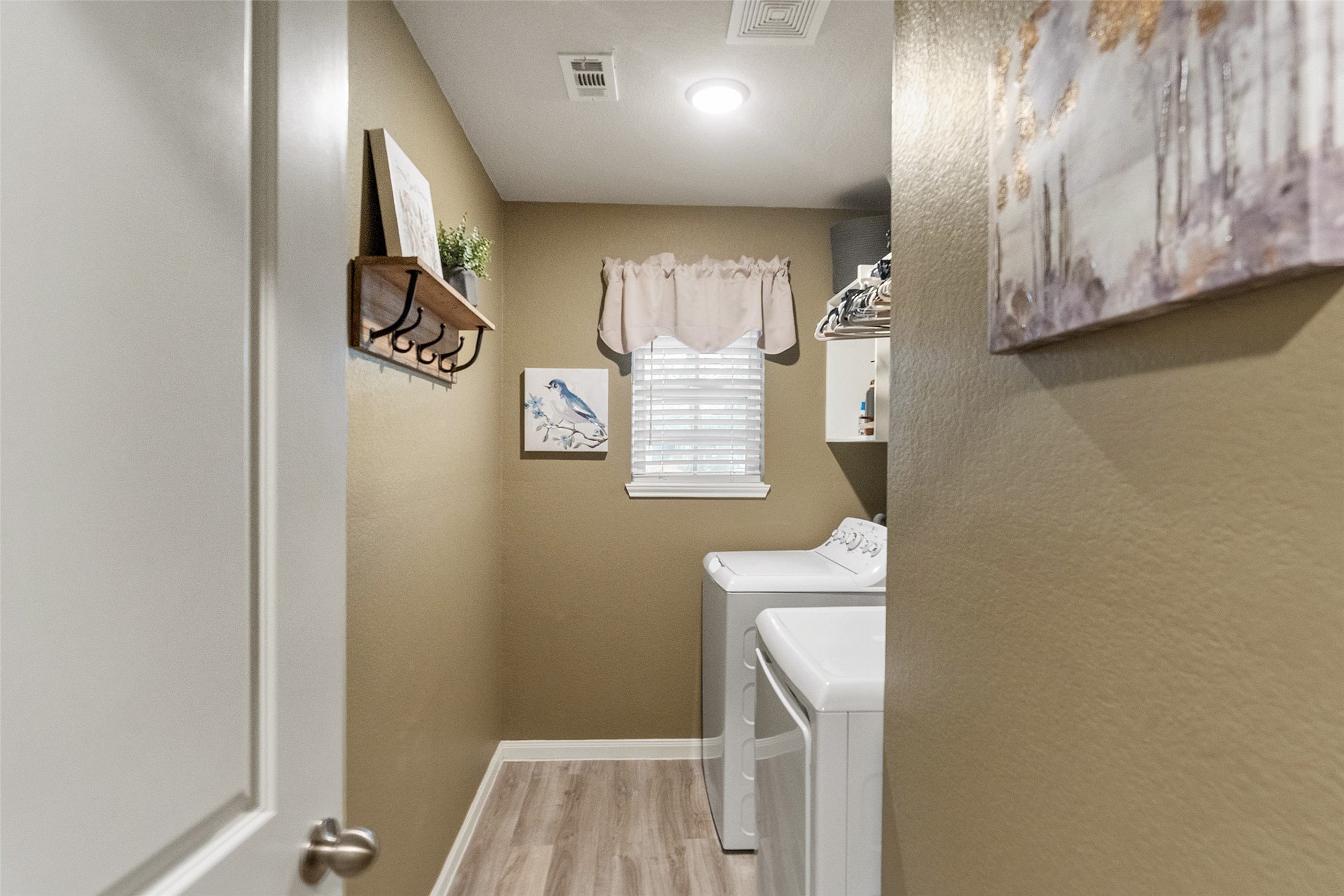 26431 Pin Oak Drive Hempstead, TX 77445 - Photo 15 of 32 Dedicated laundry room with built-in storage and hanging space for added organization. A functional setup designed to keep daily routines efficient.