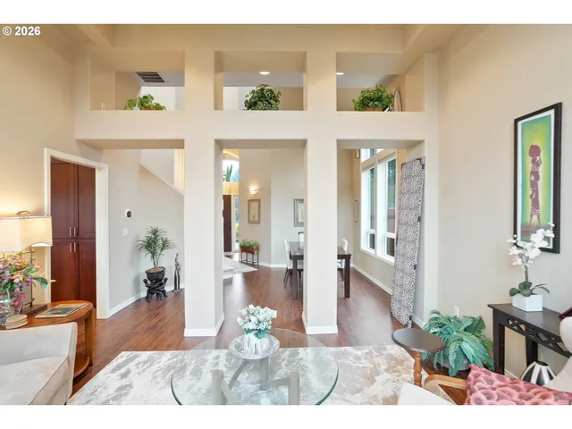 a view of a livingroom with furniture wooden floor and a bedroom