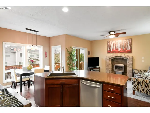 a open kitchen with stainless steel appliances granite countertop a stove and a sink with dishwasher