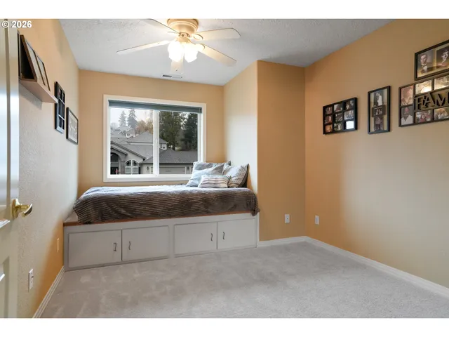 a living room with a bed furniture and a window