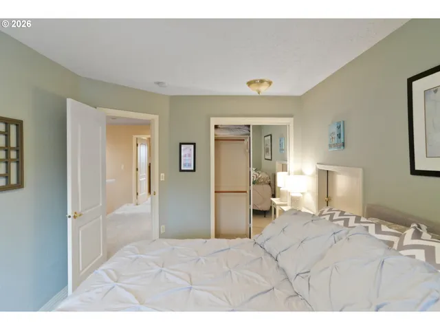 a bedroom with a bed and a mirror