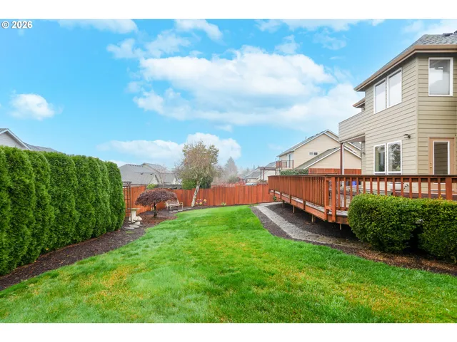 a view of a house with a big yard and potted plants