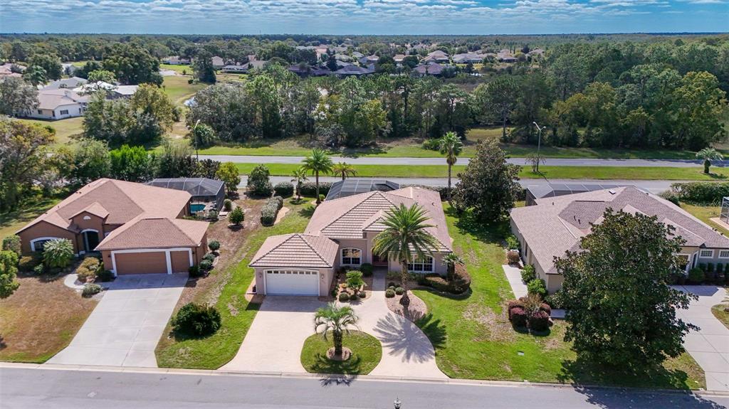 8426 Charleston Drive Weeki Wachee, FL 34613 - Photo 46 of 73 an aerial view of a house with garden space and outdoor seating
