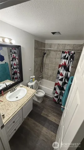 a bathroom with a double vanity sink toilet and shower