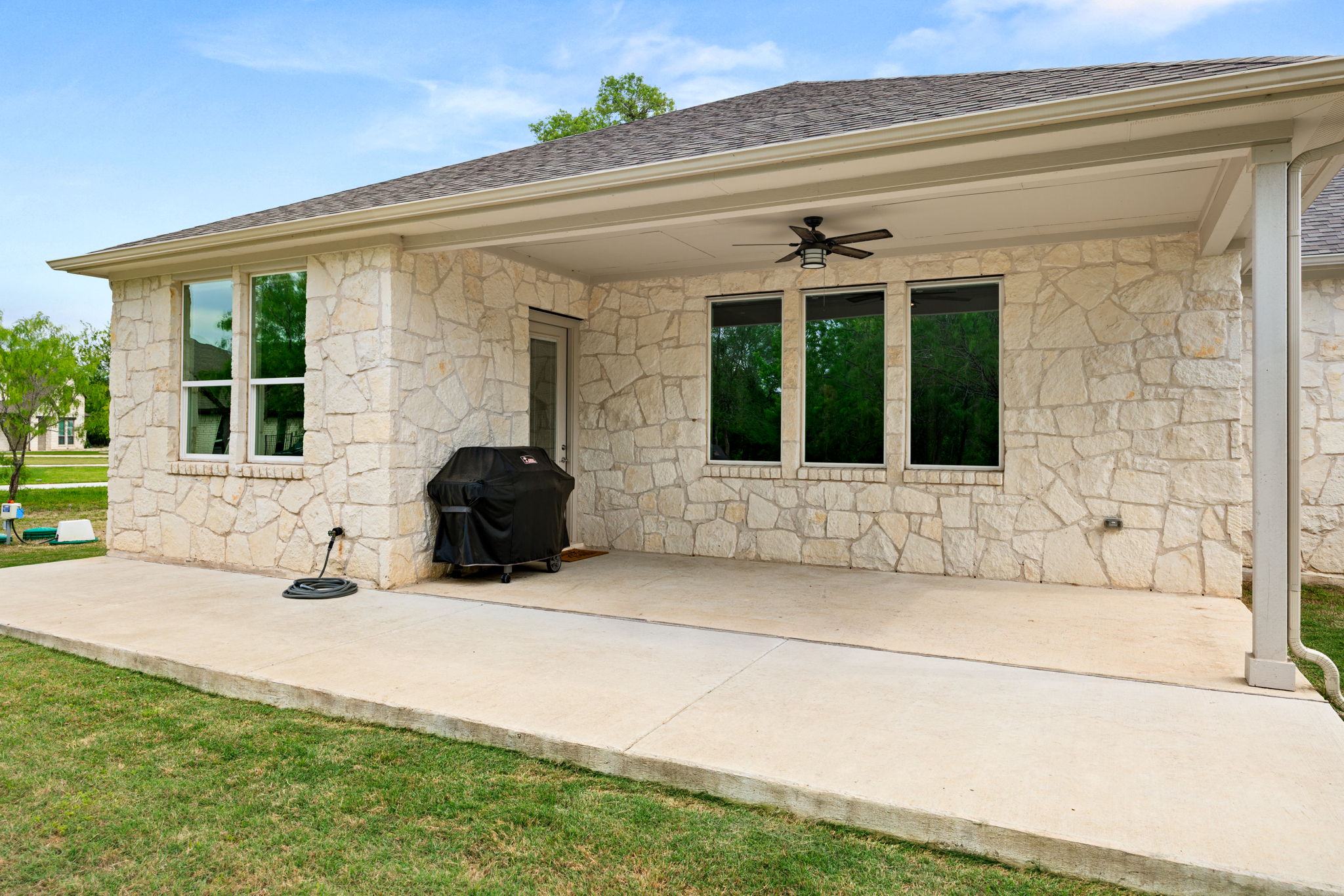 372 Raptor Beak Way Cedar Creek, TX 78612 - Photo 28 of 36 Expansive covered patio with a ceiling fan