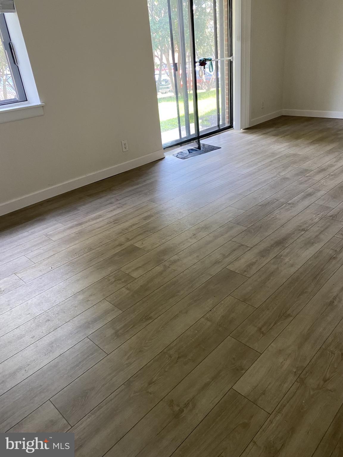 6220 Edsall Road, Unit 101 Alexandria, VA 22312 - Photo 1 of 6 a view of a livingroom with wooden floor and a window