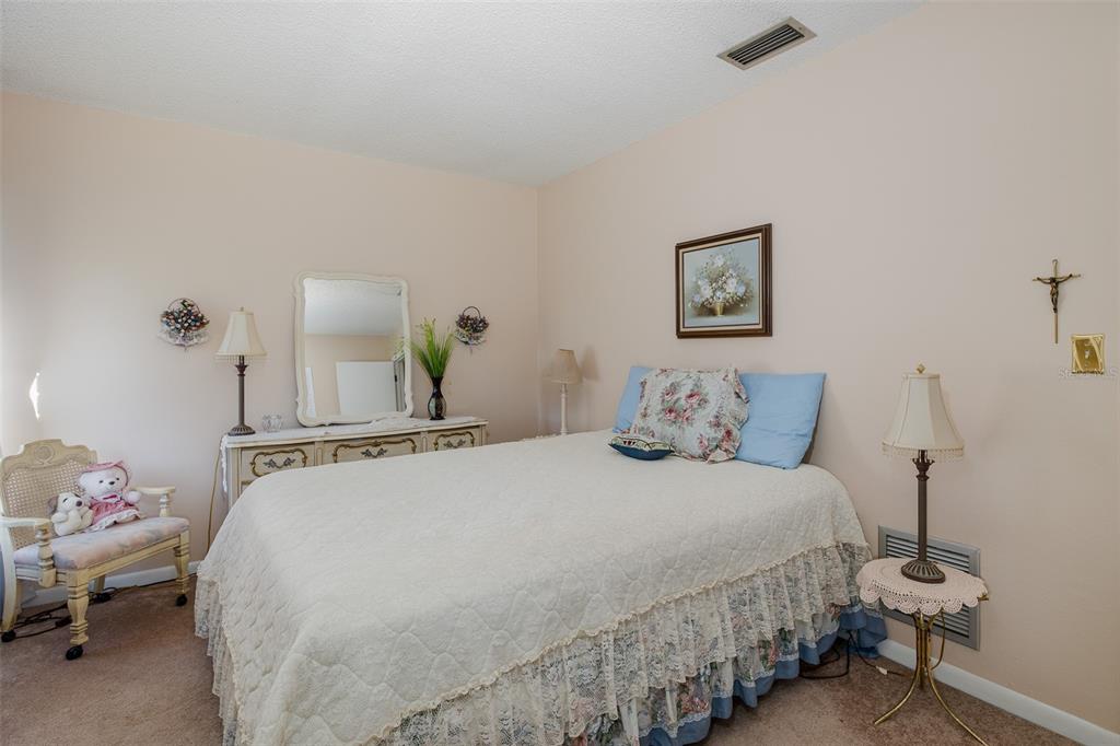 8015 San Fernando Drive Port Richey, FL 34668 - Photo 12 of 46 a bedroom with a bed and wooden floor