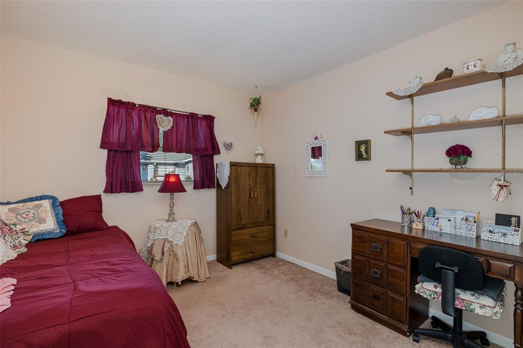 8015 San Fernando Drive Port Richey, FL 34668 - Photo 14 of 46 a bedroom with a bed and cabinets