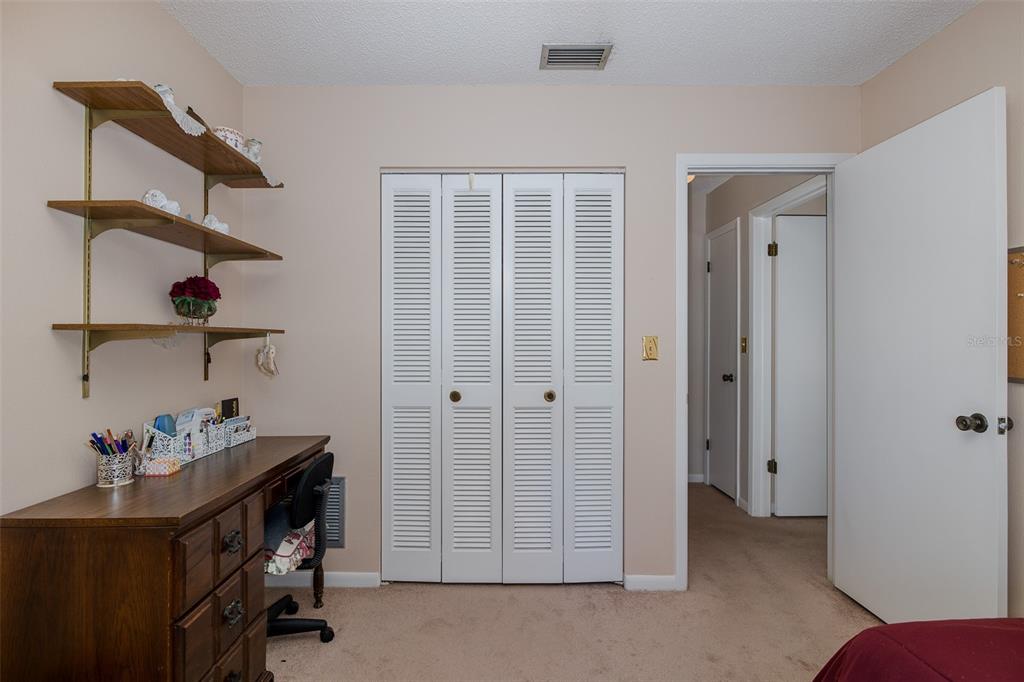 8015 San Fernando Drive Port Richey, FL 34668 - Photo 15 of 46 a view of room with baby crib and wooden floor