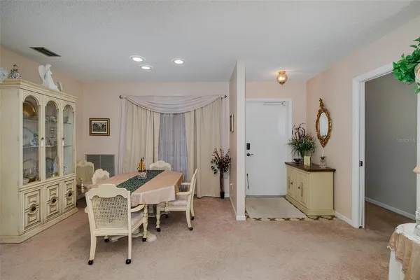 a dining room with furniture and a wooden floor