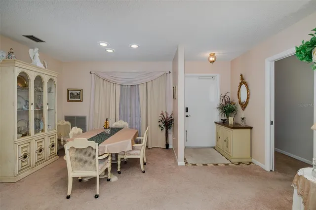 a dining room with furniture and a wooden floor