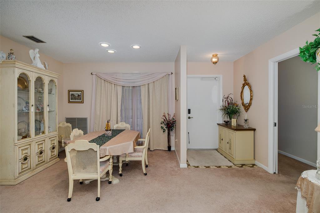 8015 San Fernando Drive Port Richey, FL 34668 - Photo 17 of 46 a dining room with furniture and a wooden floor