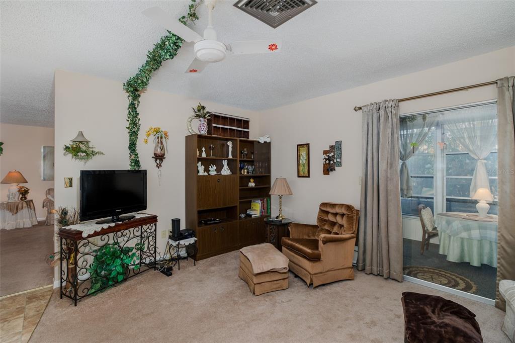 8015 San Fernando Drive Port Richey, FL 34668 - Photo 19 of 46 a living room with furniture and a flat screen tv