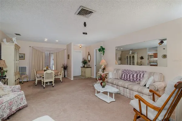 a living room with furniture and white walls