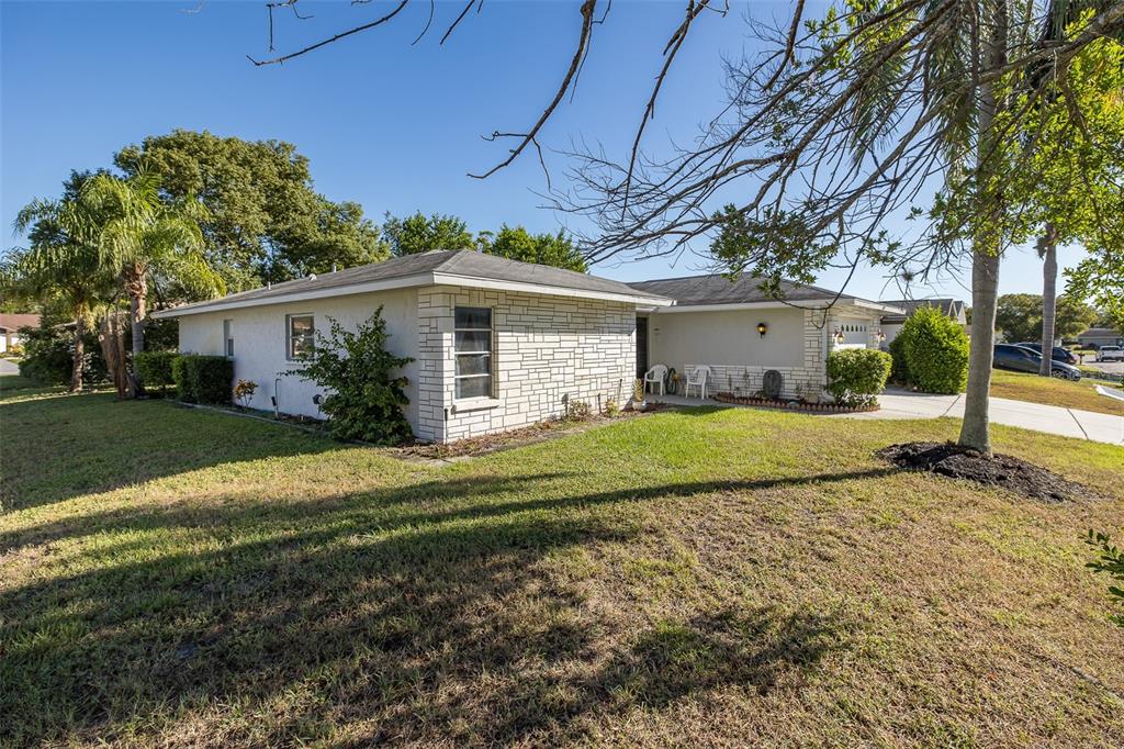 8015 San Fernando Drive Port Richey, FL 34668 - Photo 24 of 46 a front view of a house with a yard