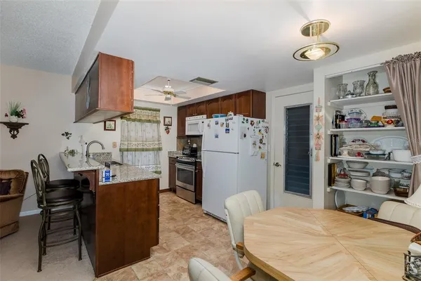 a bed room with a bed and a refrigerator