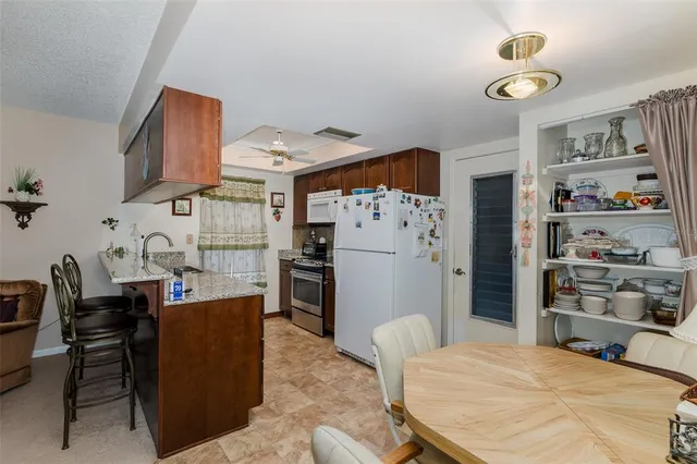 a bed room with a bed and a refrigerator