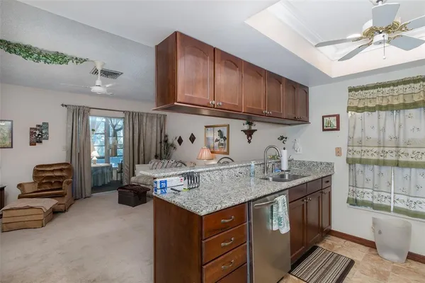 a kitchen with stainless steel appliances granite countertop a sink stove and cabinets