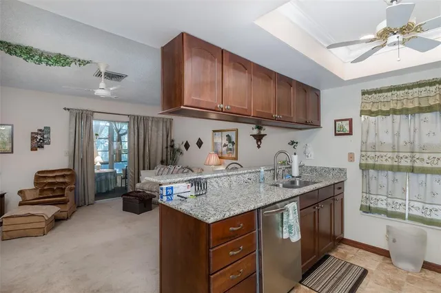 a kitchen with stainless steel appliances granite countertop a sink stove and cabinets